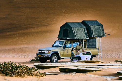 Toyota Land Cruiser with roof tent in the desert